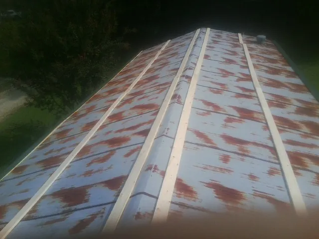 Rusted metal roof panels with new wood purlins before replacement — Storm Damage Roof Repair in Edinburgh by Roofing Brothers